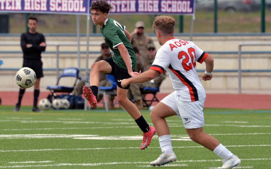 Finn Stephens of Naples passes off to a teammate against American Overseas School of Rome’s Shai Gerard in the Division II boys final at the DODEA-Europe soccer championships in Ramstein, Germany, May 22, 2025. The Wildcats beat AOSR 5-2 to take the title.