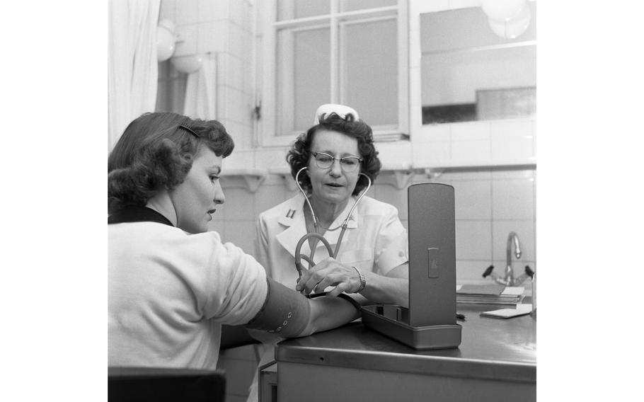 Capt. Pauline Schmickley takes the blood pressure of an unidentified female patient at the obstetrics and gynecology department at the 97th U.S. Army Hospital in Frankfurt.