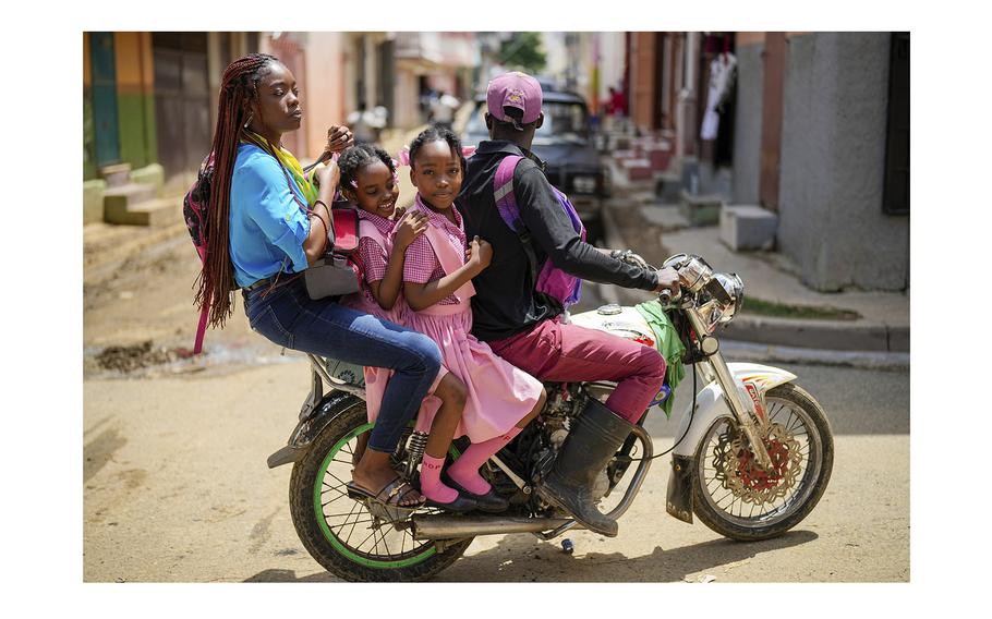 People ride on a motorcycle in Cap-Haitien, Haiti, Wednesday, April 17, 2024.