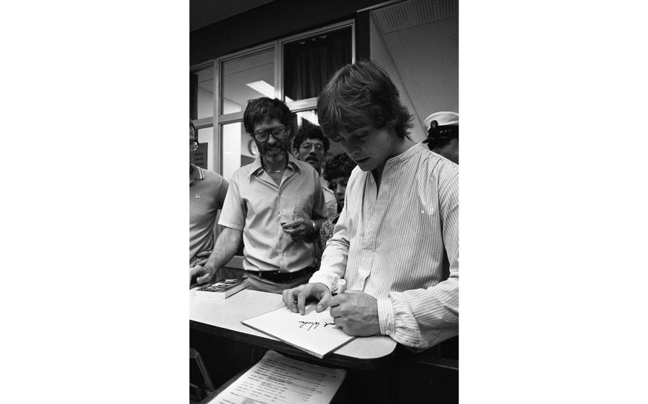 Mark Hamill, better known to many as young Jedi Luke Skywalker of Star Wars fame, signs his autograph for Principal Douglas M. Spaulding of Nile C. Kinnick High School.