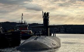 Tugboats guide the attack submarine USS Newport News away from the pier at Naval Submarine Base New London in Groton, Conn., March 12, 2025. Newport News made a port call in Iceland on July 9, marking the first time a nuclear-powered submarine has visited Icelandic shores, the Navy said.