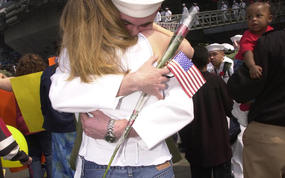 Erin Hoefer hugs her husband, Petty Officer 1st Class Ron Hoefer, upon the return of the USS Kitty Hawk.  The carrier returned Tuesday, May 6, 2003, from a deployment to the Persian Gulf, where it supported Operation Iraqi Freedom.