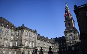 A large, old building complex seen on a sunny day. 