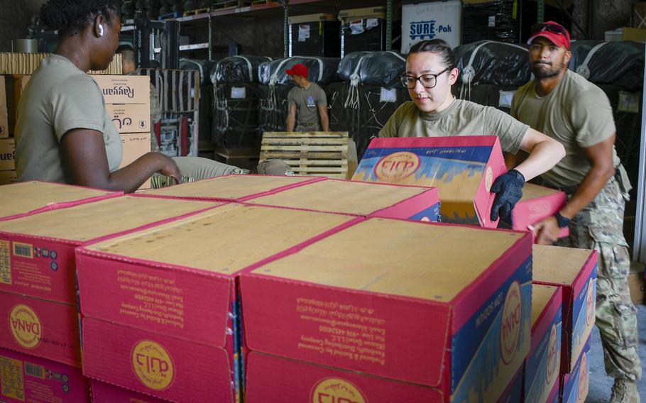 Air Force Senior Airman Sierra Olivarez stacks boxes of water onto a pallet that would later be airdropped into the Gaza Strip. Olivarez is one of more than 80 volunteers at Al Udeid Air Base, Qatar, who signed up to help with the delivery of rations and water to people in Gaza.