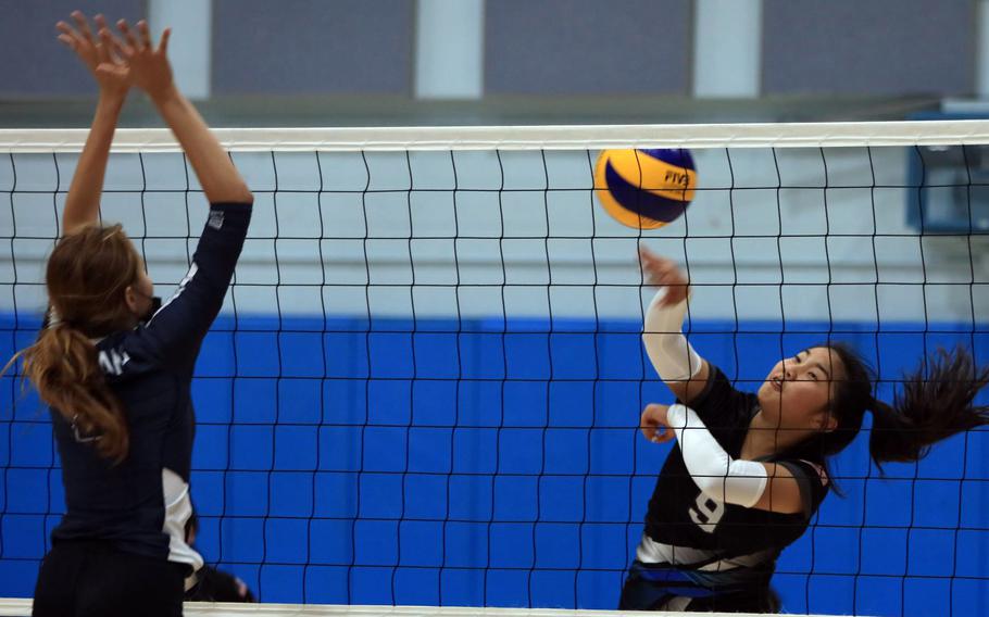 Yongsan‘s Ashley Kim spikes against Osan’s Anna Fertig during Wednesday’s Korea girls volleyball match. The Guardians won in four sets.