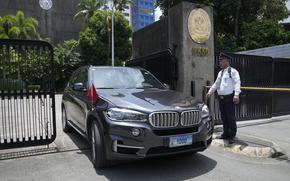 FILE - A car with diplomatic plates and Chinese flag leaves the Philippine Department of Foreign Affairs in Manila, Philippines on Aug. 7, 2023. A top Philippine security official demanded Friday May 10, 2024 the immediate expulsion of Chinese diplomats who reportedly leaked an alleged phone conversation between an embassy official and a Filipino admiral about handling the South China Sea territorial rifts, which have escalated and strained relations. (AP Photo/Aaron Favila, File)