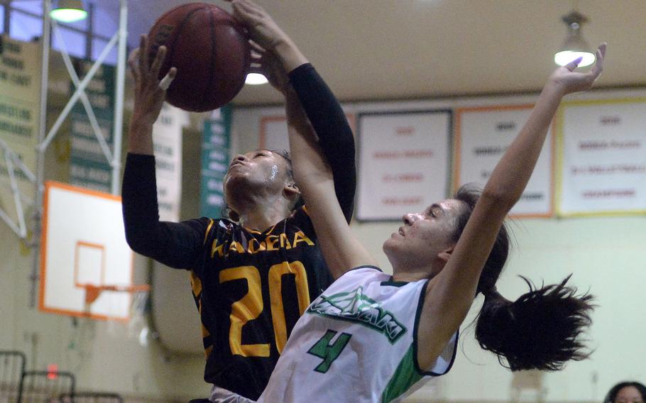 Kadena's Ayanna Levi snags a rebound against Kubasaki's Bianca Loor during Thursday's season-opening Okinawa basketball game. The Panthers won 48-2.