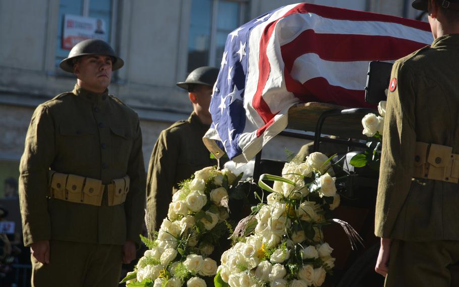 World World War I re-enactors stand at attention as a horse-drawn carriage moves a casket draped in an American flag in Chalons-en-Champagne, France,  on Oct. 24, 2021. The ceremony recreated the journey of the U.S. Unknown Soldier from the city exactly 100 years ago. 