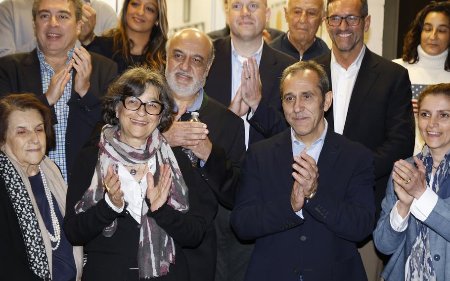 U.S officials arrange a group photo after freed Americans Siamak Namazi, Morad Tahbaz and Emad Shargi, as well as two returnees not yet named by the U.S. government, who were released in a prisoner swap deal between U.S and Iran, arrived at Davison Army Airfield, Tuesday, Sept. 19, 2023, at Fort Belvoir, Va. 