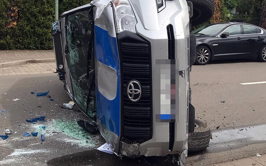 A military police vehicle sits on its side after the driver lost control, hit a parked car and then overturned, blocking Kaiserstrasse in Kaiserslautern, Germany, May 21, 2021, near Pulaski Barracks, local police said.

Police department Westpfalz 