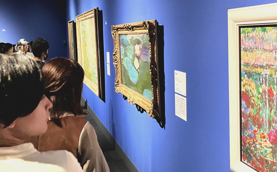 Visitors wait patiently for an up-close look at selections from Claude Monet’s water lily series on exhibt at Ueno Royal Museum in Tokyo, Nov. 4, 2023.