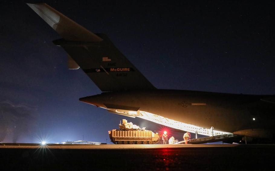 U.S. soldiers unload M2A3 Bradley Fighting Vehicles from an Air Force C-17 Globemaster in northeastern Syria on Jan. 31, 2022. U.S. troops and partner forces launched hundreds of operations against the Islamic State in Syria and Iraq this year, U.S. Central Command said.