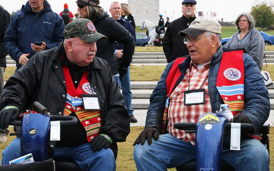 Honor Flight visitors from Oklahoma wait for the start of the Veterans Day ceremony at the National World War II Memorial in Washington, November 11, 2023.