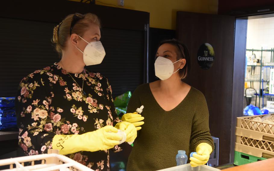 Volunteers Emma Harre, left, and Erin Gonzalez clean baby bottles at Ramstein Air Base, Germany, on Sept. 15, 2021. Volunteers have cleaned and sanitized more than 10,000 baby bottles for Afghan evacuees at Ramstein and Rhine Ordnance Barracks in less than a month.