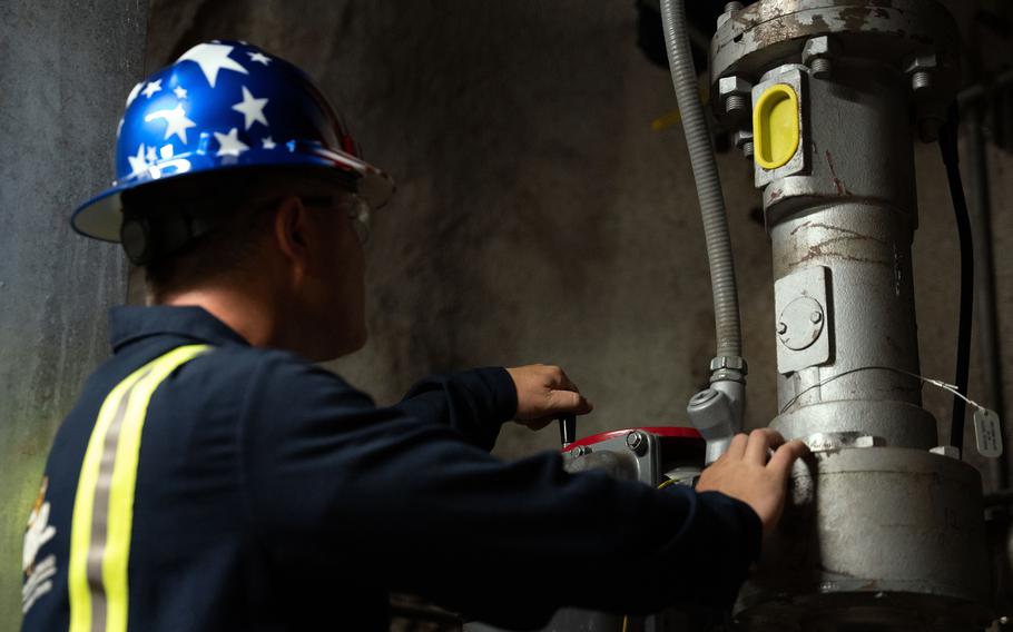 A Navy official inspects fuel gauges and pipes at the Red Hill Bulk Fuel Storage Facility in Halawa, Hawaii, Sept. 5, 2023.