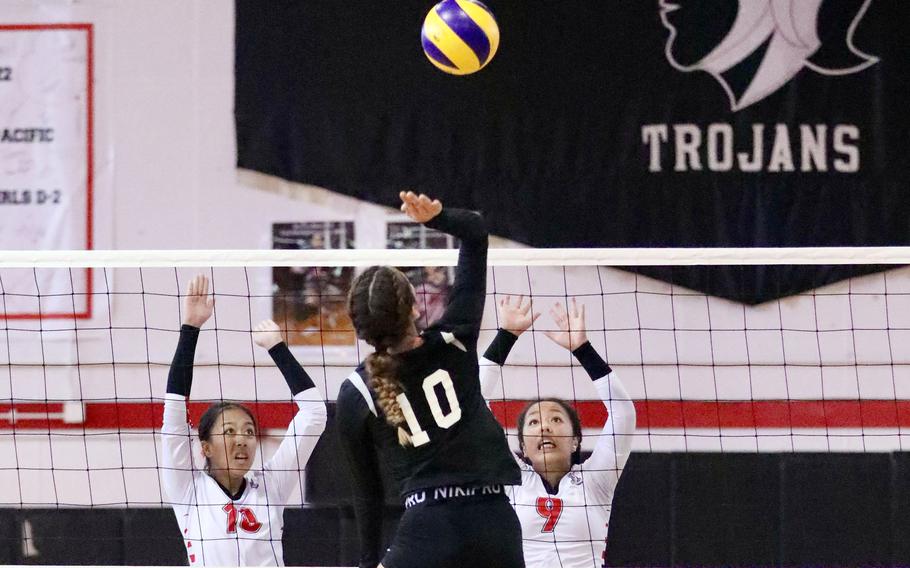 Zama's Emma Sakamoto-Flack goes up to spike against E.J. King's Pia Lagrito and Kaitlyn Mapa during Friday's DODEA-Japan girls volleyball match. The teams split their weekend series, Zama winning in five sets Friday and King in four sets Saturday.