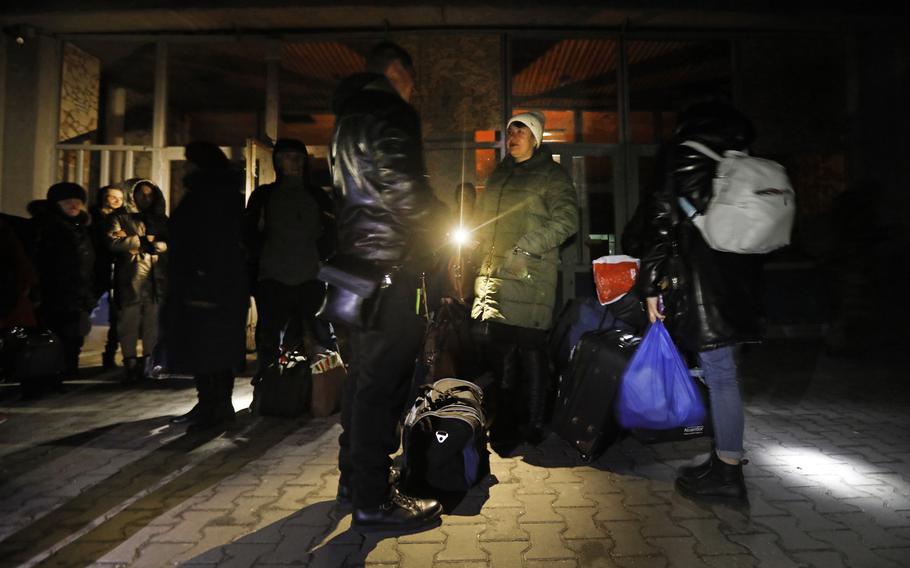 At the train station in Mykolaiv, people traveling to Kyiv, Ukraine’s capital, wait in the darkness. Electricity is out in Mykolaiv after Russian forces bombed multiple power stations.