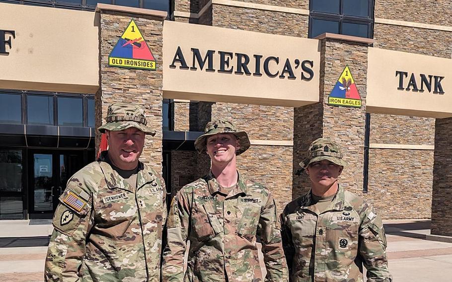 Maj. Gen. James Isenhower III, commander of 1st Armored Division, Spc. Christian Sutton and Command Sgt. Maj. James Light wear their Army sun hats, better known as boonies, at the Texas base.