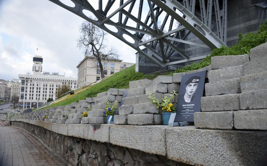 A notch displays an image of a Ukrainian killed as part of the recent war with Russia, as part of a display in which each notch holds information about another death, next to the Maidan Nezalezhnosti, Kyiv’s central square, on Oct. 26, 2022.