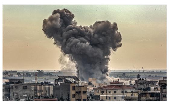 Smoke rises from buildings after Israeli airstrikes in Rafah, on Dec. 14, 2023. 