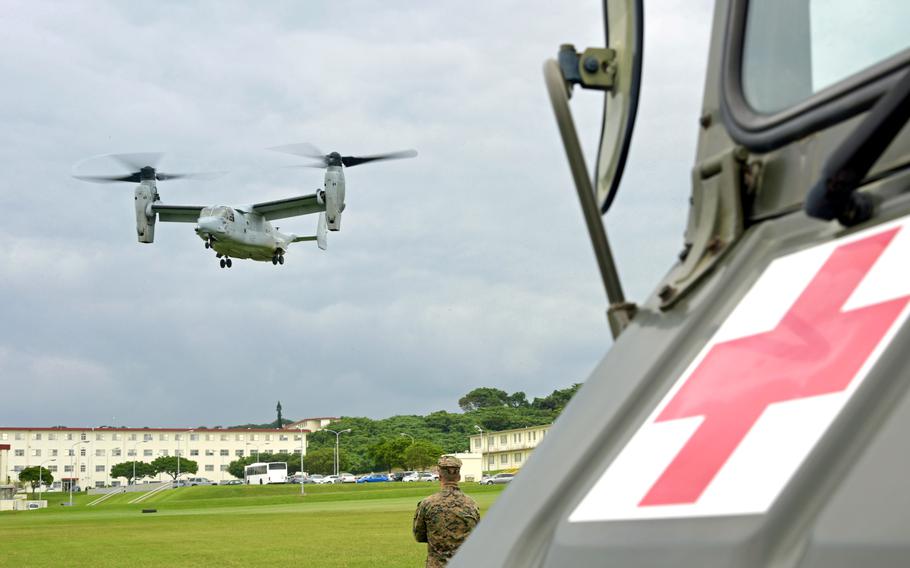 A U.S. Marine watches an MV-22B Osprey land as part of exercise Keen Sword 23 at Camp Foster, Okinawa, Japan, on Nov. 15, 2022.
