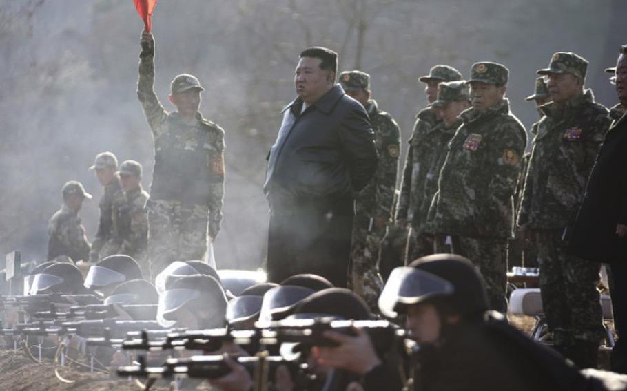 North Korean leader Kim Jong Un, center, observes marksmanship training at an undisclosed military base in North Korea on March 6, 2024.