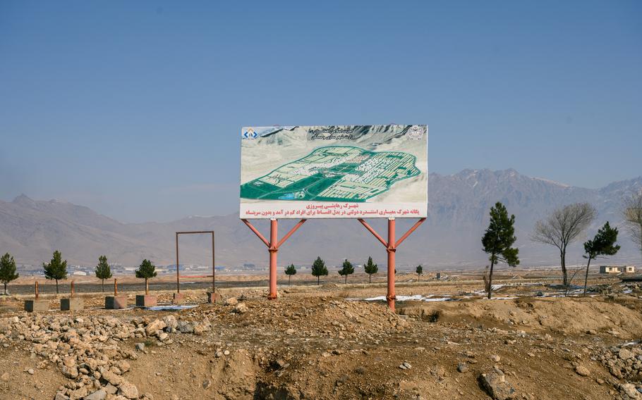 A billboard advertises Kabul’s “New City,” which was first conceived almost two decades ago under the U.S.-backed government but was never built.