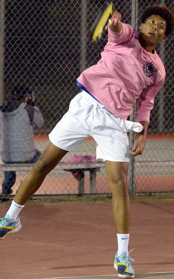 Yokota's Zemon Davis serves to Christian Academy Japan's Joe Byrd during Wednesday's Kanto Plain tennis matches. Byrd won 8-4.