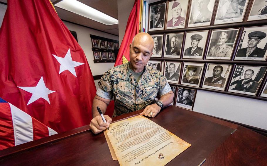 The 1st Marine Aircraft Wing's commander, Maj. Gen. Brian Cavanaugh, signs a proclamation changing the wing's call sign from “Ice pack” to “Cactus," Monday, Aug. 8, 2022. The ceremonial switch was a callback to the Cactus Air Force that operated from Henderson Field during the six-month World War II fight on Guadalcanal in the Solomon Islands.