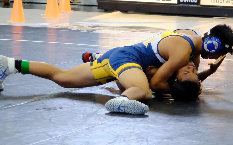 Guam High 152-pounder Tavion Duenas pins John F. Kennedy's Michael Stith in 3 minutes, 16 seconds, during Saturday's Guam wrestling quad meet. The Panthers won the meet 54-14.