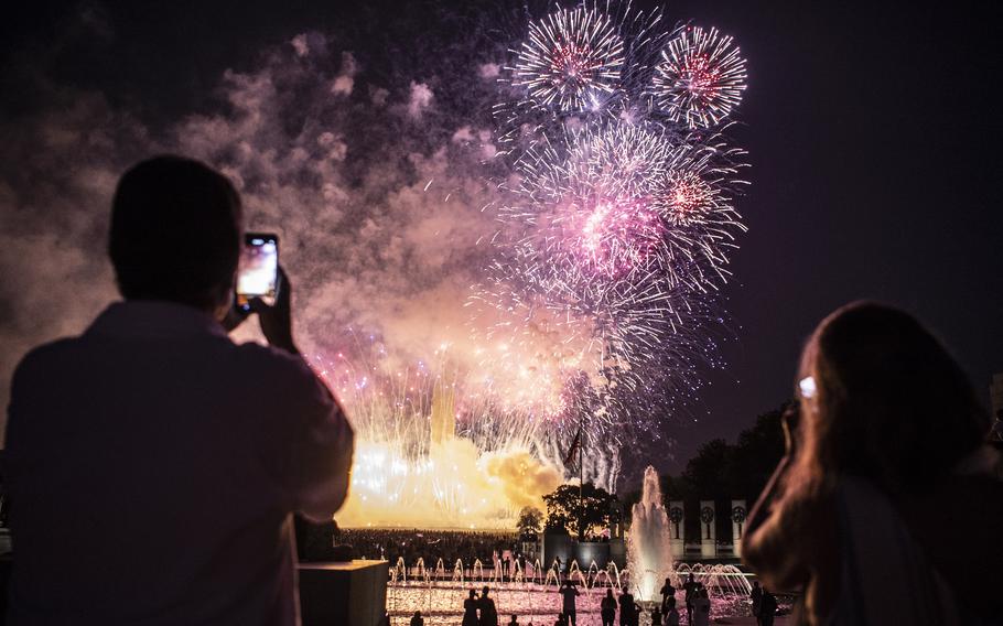 Spectators view the Independence Day fireworks display at the World War II Memorial in Washington, D.C. on July 4, 2020.