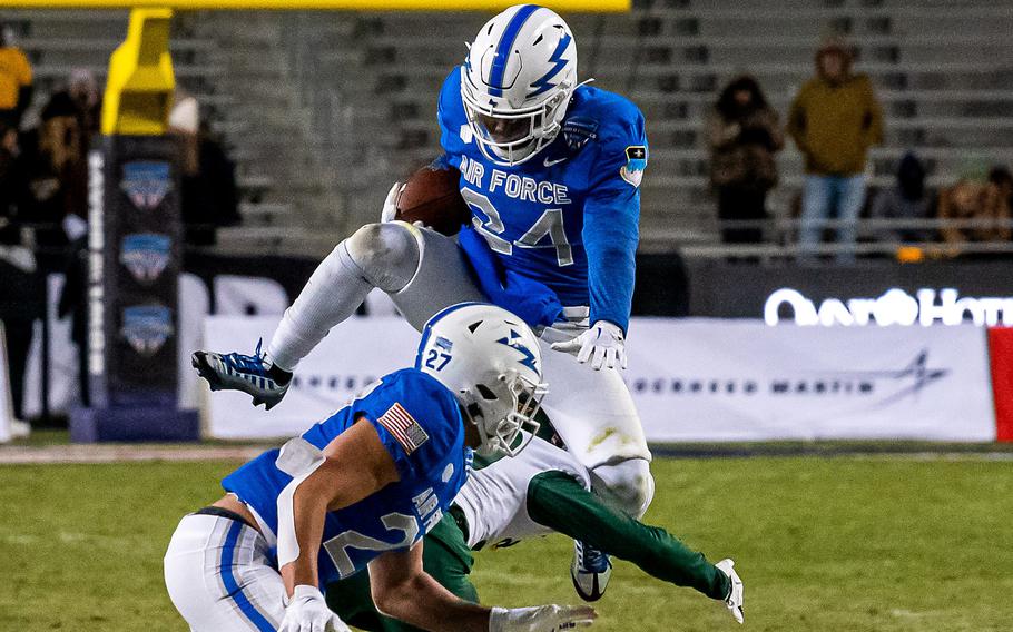 Air Force’s John Lee Eldridge III leaps over a Baylor defender on Dec. 22, 2022 during the Armed Forces Bowl at Amon G. Carter Stadium in Fort Worth, Texas. Eldridge averaged 7.7 yards per carry in 2022.