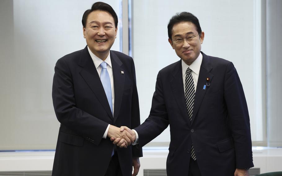 South Korean President Yoon Suk Yeol, left, shakes hands with Japanese Prime Minister Fumio Kishida before their meeting in New York on Sept. 21, 2022. South Korea’s president wants Japan to join his efforts to improve ties frayed over Tokyo’s past colonial rule, saying there is an increasing need for greater bilateral cooperation because of North Korean nuclear threats and global supply chain challenges.
