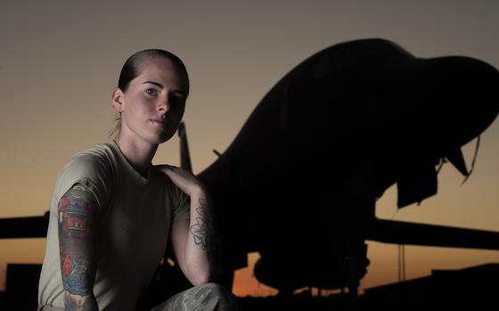 Senior Airman Autumn Rosado, 9th Aircraft Maintenance Unit avionics technician and a tattoo artist in her off-duty time, shows off her tattoos in front of a B-1B Lancer at Dyess Air Force Base, Texas, Sept. 18, 2019. A newly released Air Force regulation now allows airmen limited neck and hand tattoos.