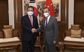 In this photo released by Xinhua News Agency, South Korean Foreign Minister Park Jin, left, shakes hands with his Chinese counterpart Wang Yi before head to their meeting in Qingdao in east China's Shandong province, Tuesday, Aug. 9, 2022. South Korea on Wednesday stressed it will make its own decisions in strengthening its defense against North Korean threats, rejecting Chinese calls to inherit the polices of Seoul's previous government that refrained from adding more U.S. anti-missile batteries that raise security jitters in Beijing. (Li Ziheng/Xinhua via AP)