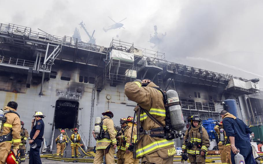 Sailors and federal firefighters respond to a blaze aboard the amphibious assault ship USS Bonhomme Richard at Naval Base San Diego, July 13, 2020. 