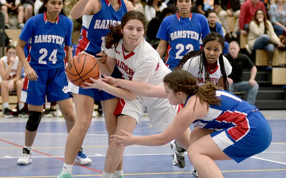 Kaiserslautern’s Rihanna Martin fights off Ramstein’s Katya von Eicken as the Royals’ Rachel Sorenson defends during pool play of the Division I DODEA European Basketball Championships on Thursday at Ramstein High School on Ramstein Air Base, Germany.