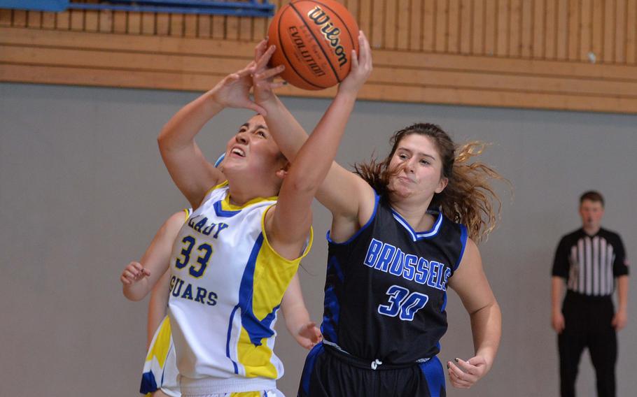 Brussels’ Abagail Halttunen reaches in to try to grab a rebound from Sigonella’s Leila Denton in a D-III game on opening day of the DODEA-Europe basketball finals in Baumholder, Germany, Feb. 15, 2023. Sigonella beat the Brigands 39-6. 