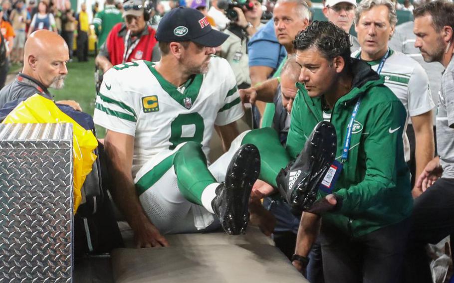 Medical personnel lift New York Jets quarterback Aaron Rodgers (8) onto a cart after he was injured during the Jets first set of downs against the Buffalo Bills on Monday, September 11, 2023, in East Rutherford, N.J.