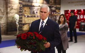 Former U.S. vice president Mike Pence lays a wreath during his visit to the Iranian opposition headquarters in Albania, about 30 kilometers (16 miles) west of Tirana, Albania, Thursday, June 23, 2022. (AP Photo/Franc Zhurda)