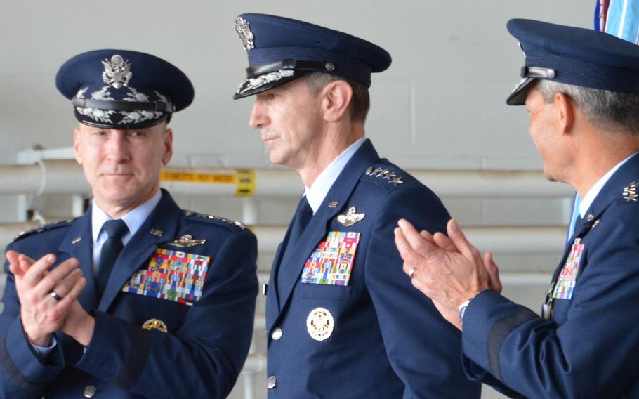 Gen. David Allvin, left, and Gen. Ken Wilsbach, right, applaud Gen. Kevin Schneider after he assumed command of Pacific Air Forces during a ceremony at Joint Base Pearl Harbor-Hickam, Hawaii, on Feb. 9, 2024.