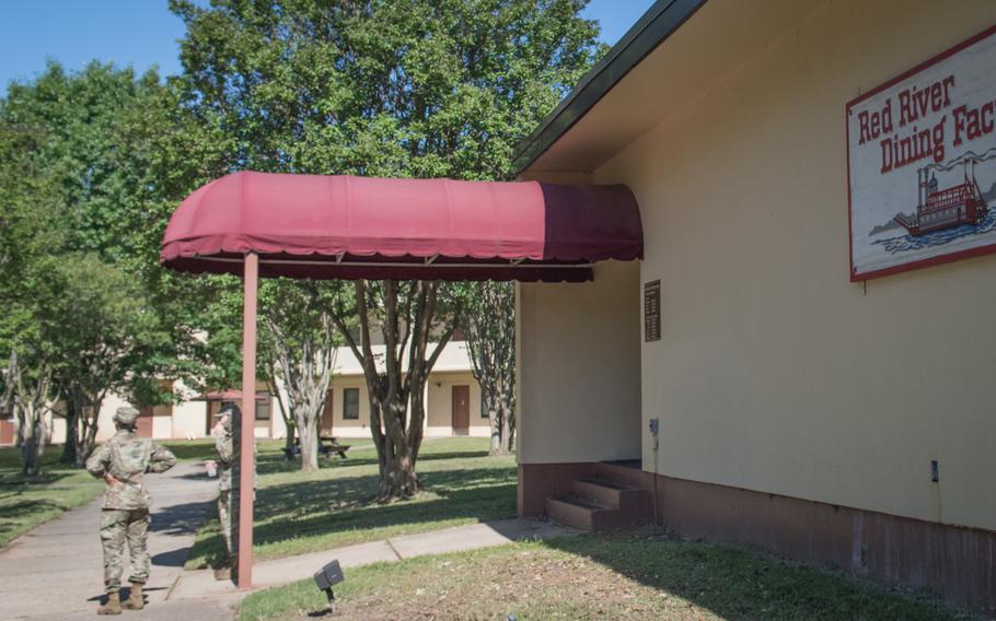 Airmen stand outside waiting for the Red River Dining Facility to open for lunch at Barksdale Air Force Base, La., in 2020. 