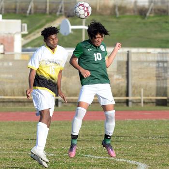 Kadena's Calvin Paguada and Kubasaki's Seira Fowler go up to head the ball during Wednesday's Okinawa boys soccer match. The Panthers won 3-2.