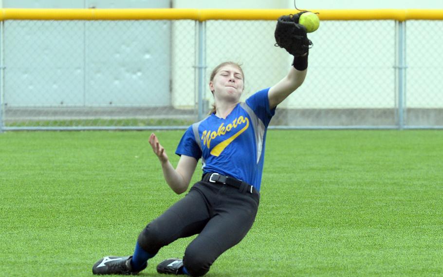 Yokota center fielder Zaylee Gubler can't quite get the handle on a Kadena fly ball.