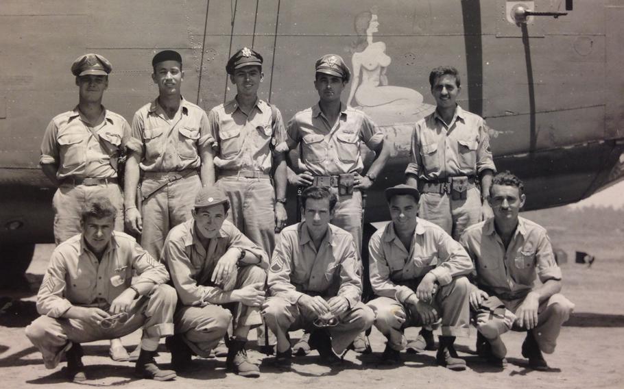 A group shot of the bomber crew standing in front of the plane.