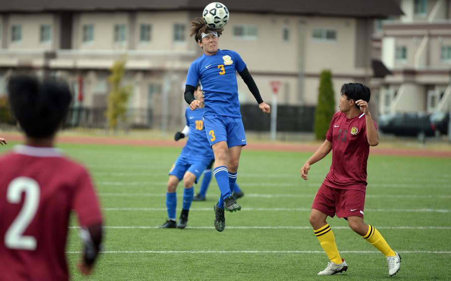 Yokota's Brandon Christenson heads the ball against Matthew C. Perry during Saturday's DODEA-Japan boys soccer match. The Panthers won 1-0.