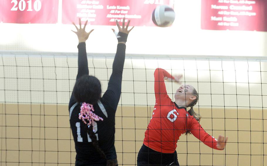 E.J. King’s Madylyn O’Neill spikes against Zama‘s Kierstyn Aumua during Friday’s Japan volleyball match. The Trojans rallied from two sets down to win in five sets.
