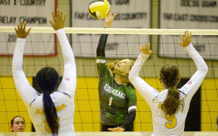 Kubasaki's Emma Leggio spikes through the double block of Kadena's Kyleigh Wright and Morgan Sayers during Tuesday's Okinawa volleyball match. The Dragons beat the Panthers in straight sets for the fifth time this season.