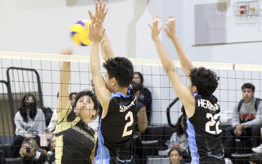 Humphreys' GianCarlo Rivera spikes against the double block of Osan's M.J. Seibert and Zack Hernandez during Saturday's DODEA-Korea boys volleyball match. The Cougars won in five sets.