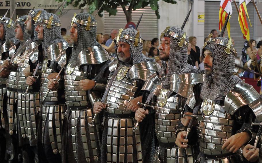 Knights join a street parade in 2019 during a Moors and Christians (Moros y Cristianos) historical reenactment in Spain.